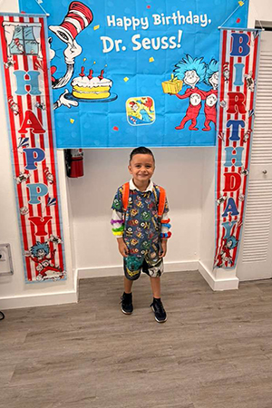 Child celebrating Dr Seuss day at early literacy preschool Miami