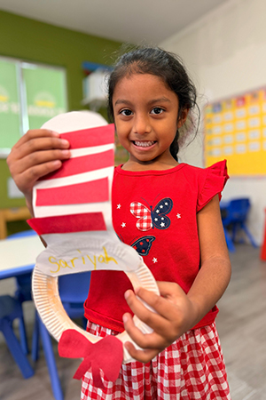 Child participating in literacy activity at early literacy preschool Miami