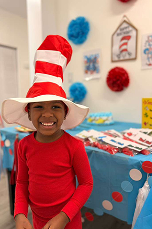 Child dressed as Cat in the Hat at early literacy preschool Miami