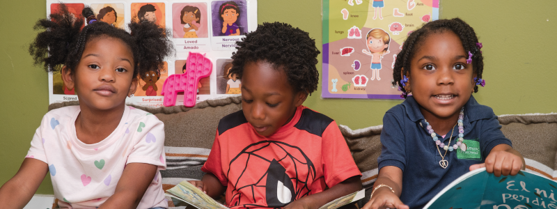 Preschool children enjoying story time at SF School Preschool students reading books together in the classroom at SF School
